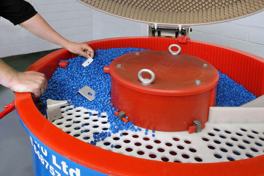 Stress relieving sheet metal with a Vibratory Bowl