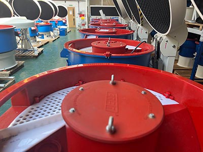PDJ Vibro - Deburring & Polishing Experts Vibratory machines lined up in the factory