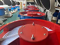 row of vibratory finishing machines